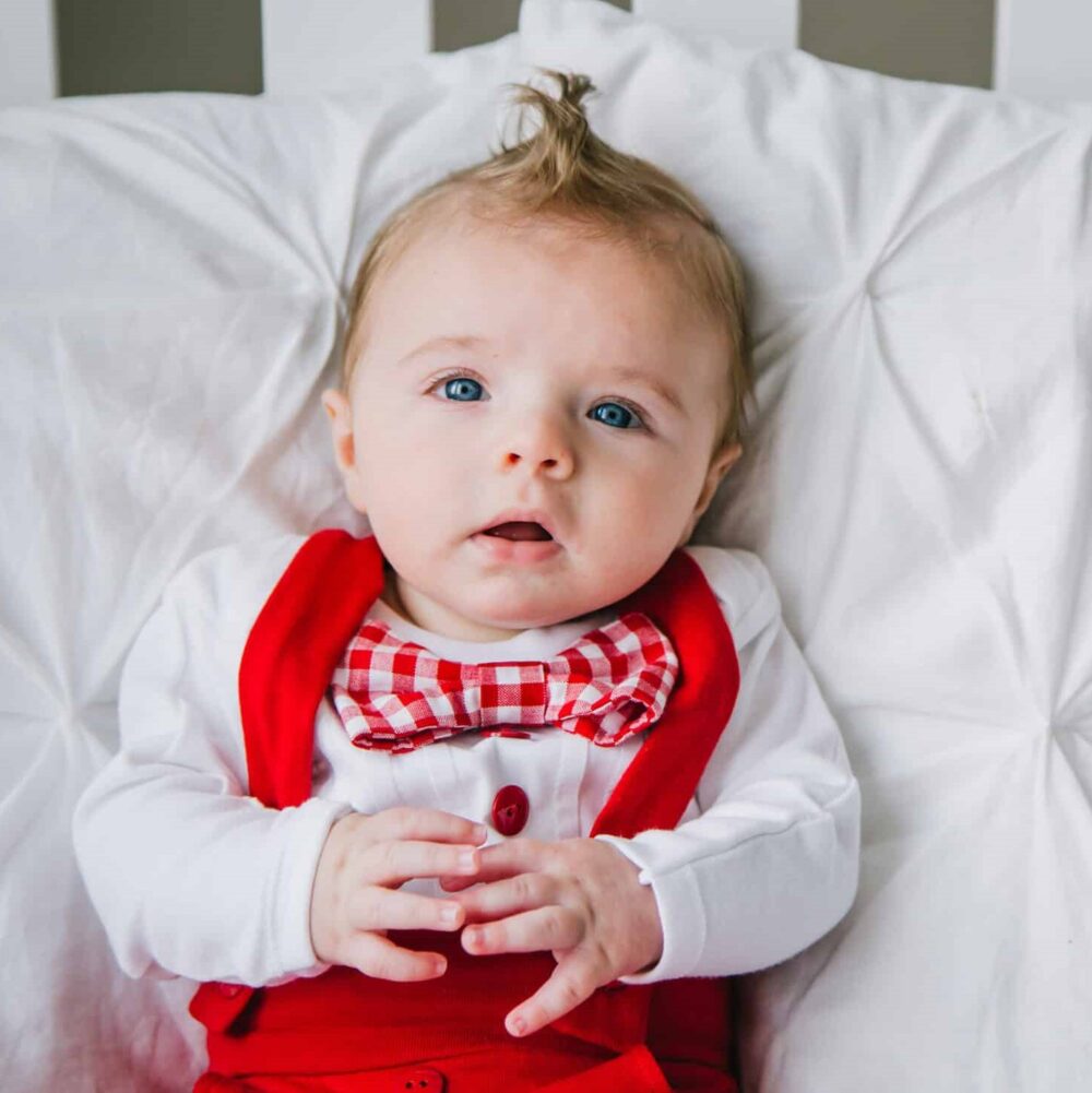 baby wearing red holiday outfit