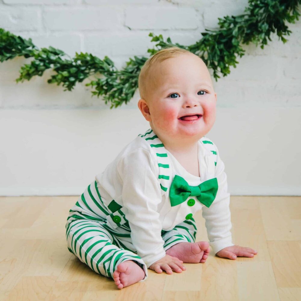 baby wearing a Bebe Couture green and white striped baby holiday outfit