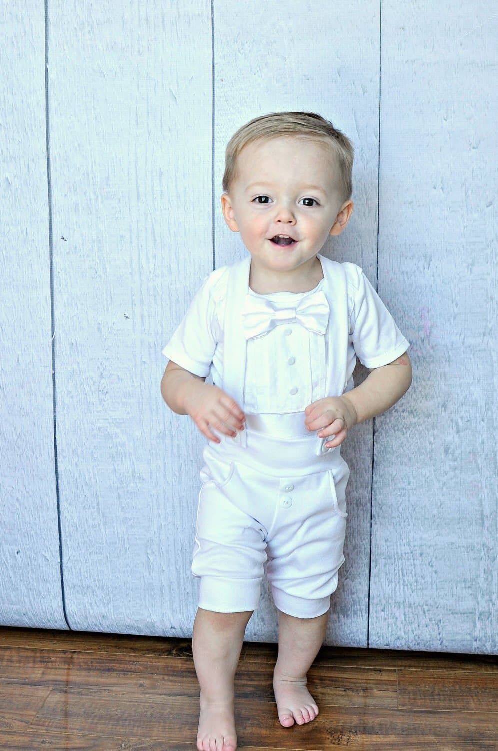toddler boy wearing Bebe Couture 2 piece white summer christening outfit with shorts