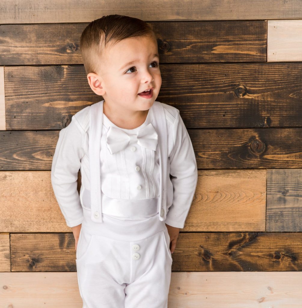 Toddler boy wearing white baby boy tuxedo