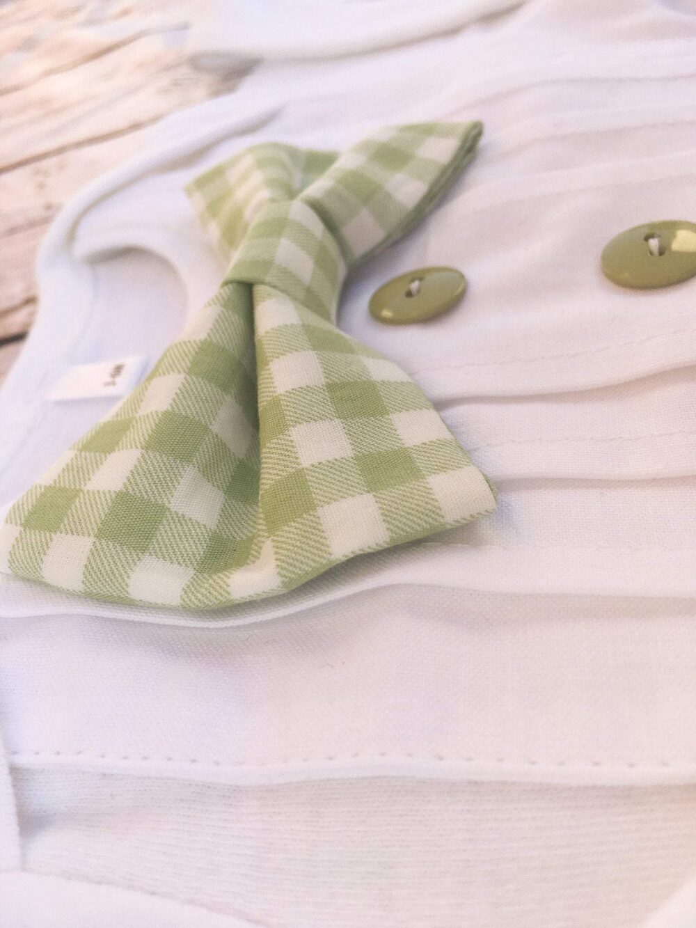 sage green and white gingham bow tie, side view